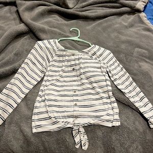 Long sleeve tee with buttons down the middle and a tie at the bottom